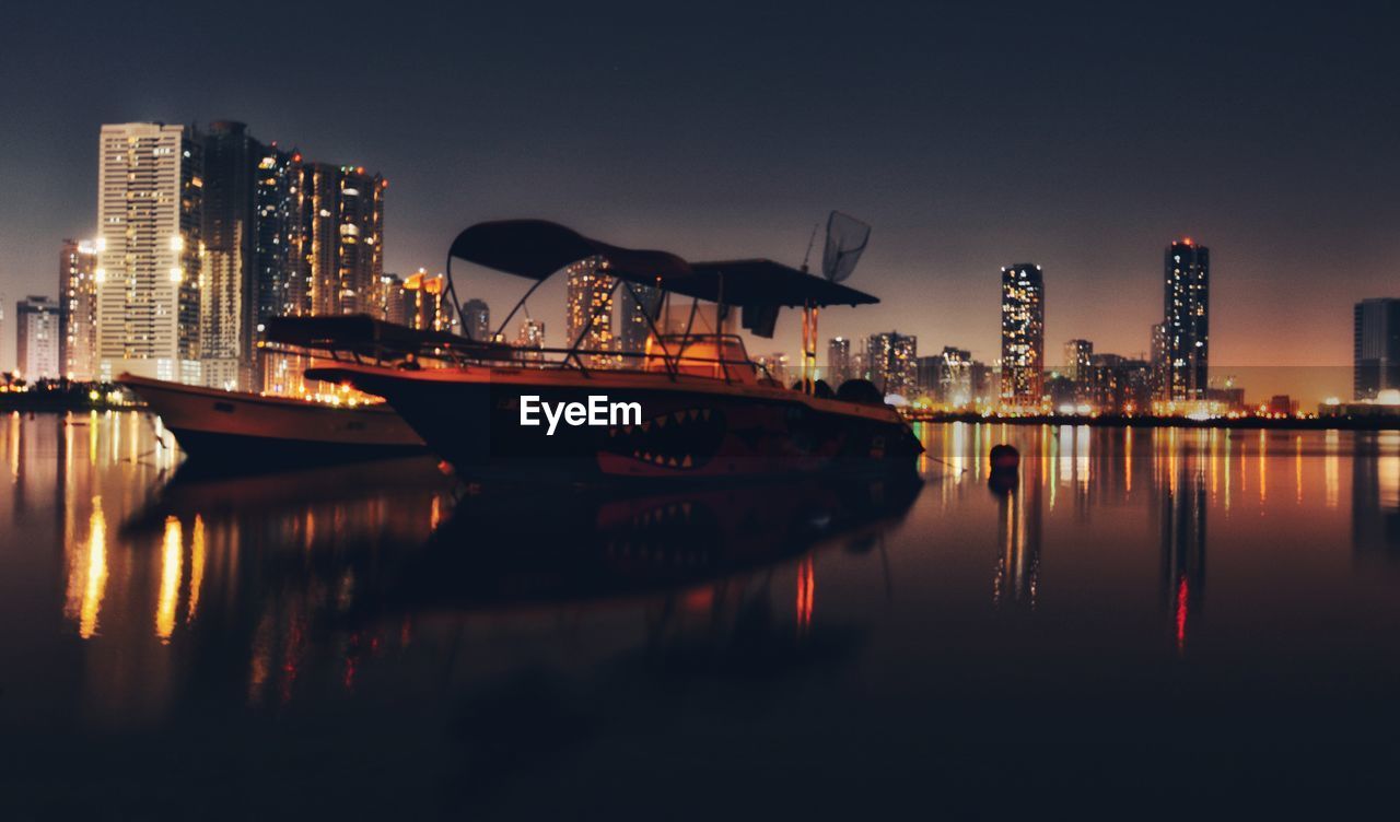 BOATS MOORED AT WATERFRONT