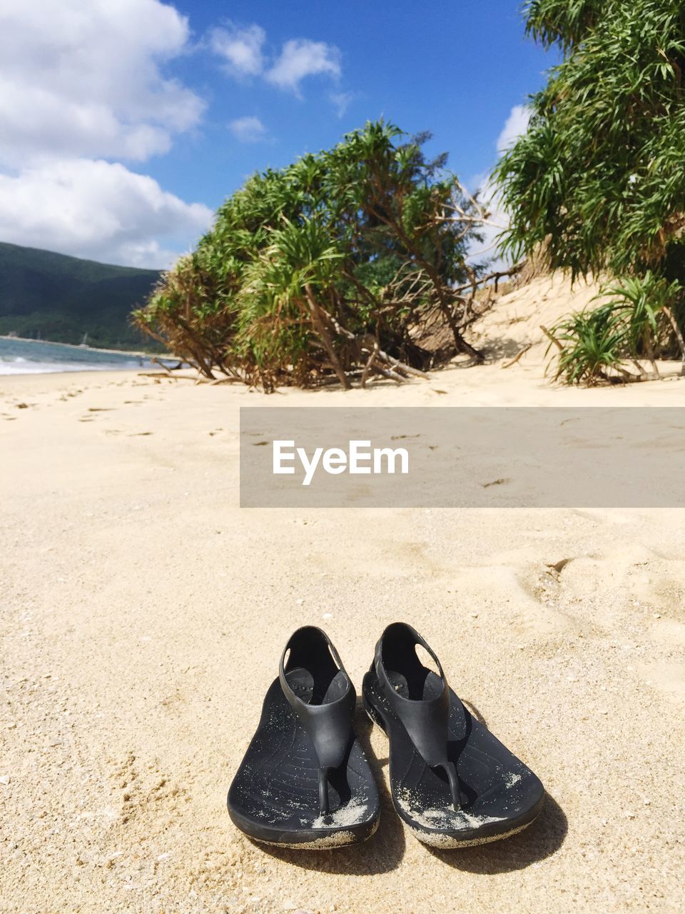 SHOES ON BEACH AGAINST SKY