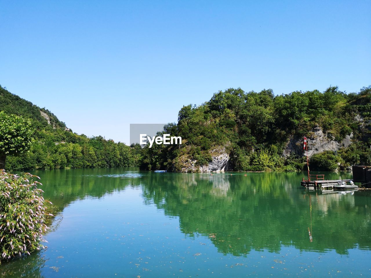 Scenic view of lake against clear blue sky. scenic view of river and mountain against sky