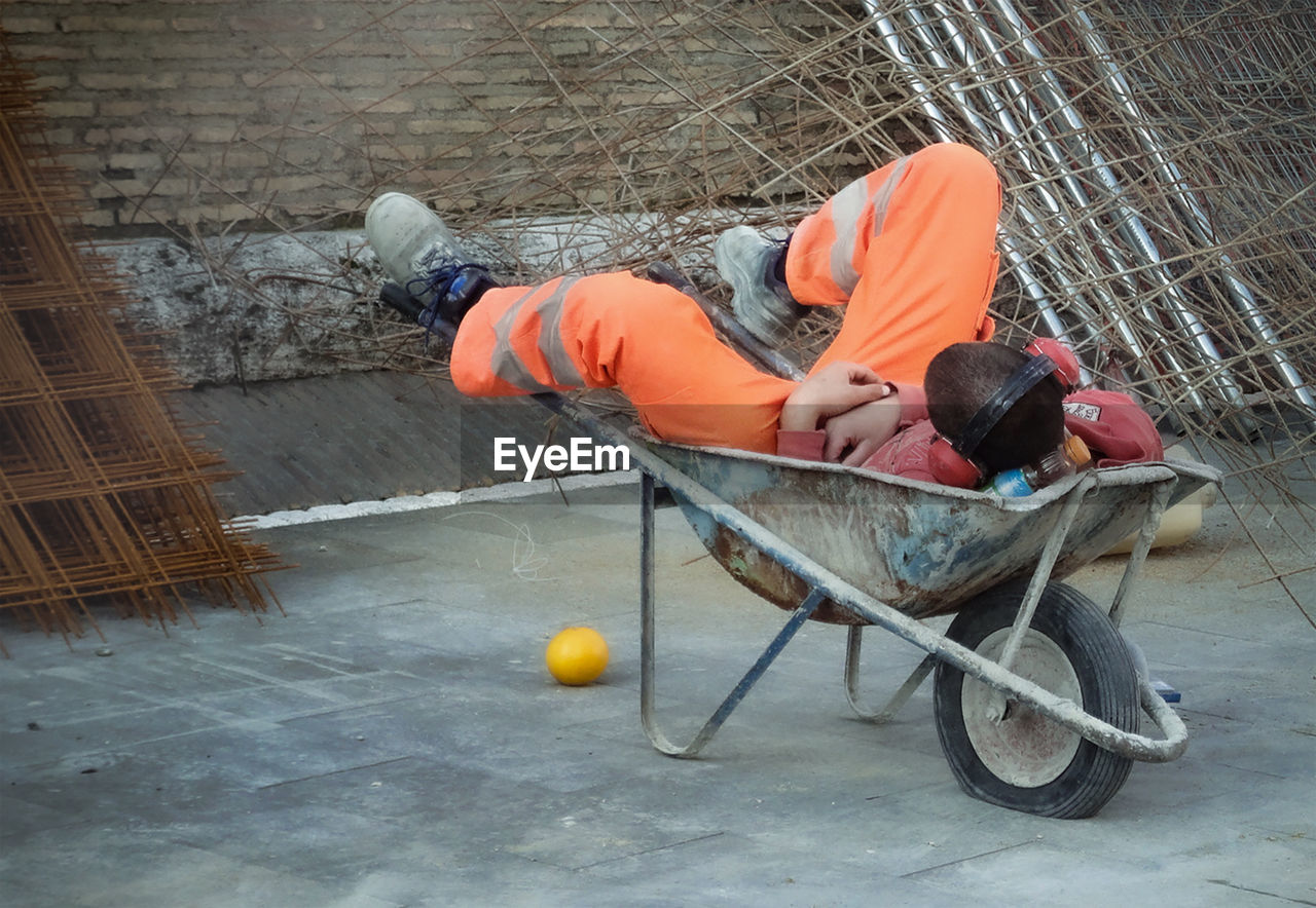 HIGH ANGLE VIEW OF MAN WORKING ON FLOOR