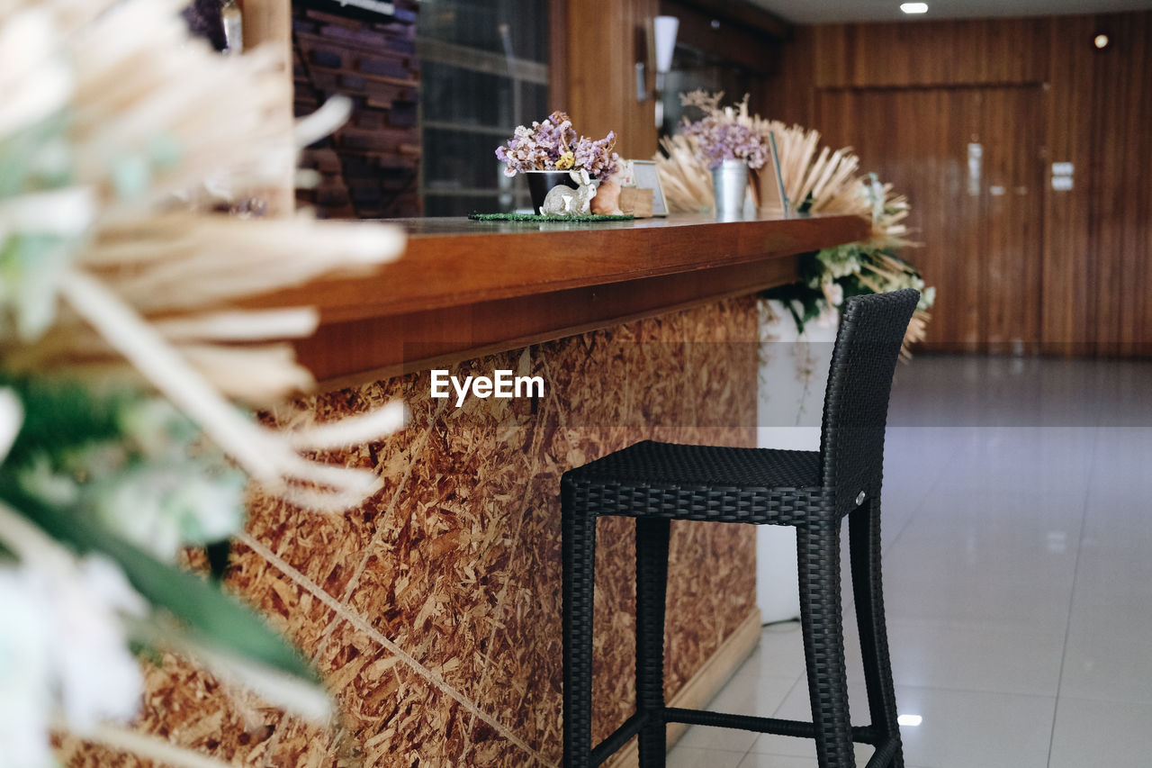 Brown wicker rattan chair at bar counter at cafe coffee shop