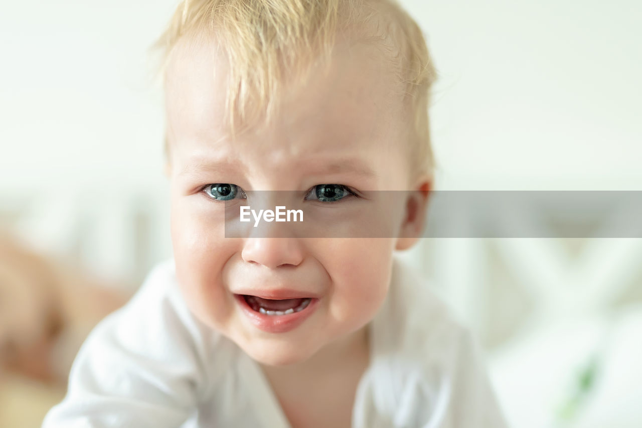 Portrait of cute baby boy crying