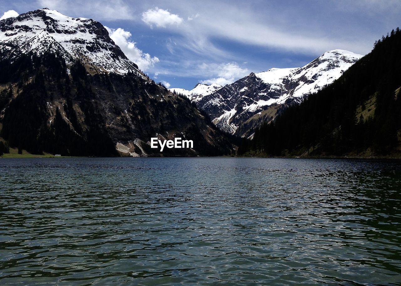 Scenic view of lake and mountains against sky