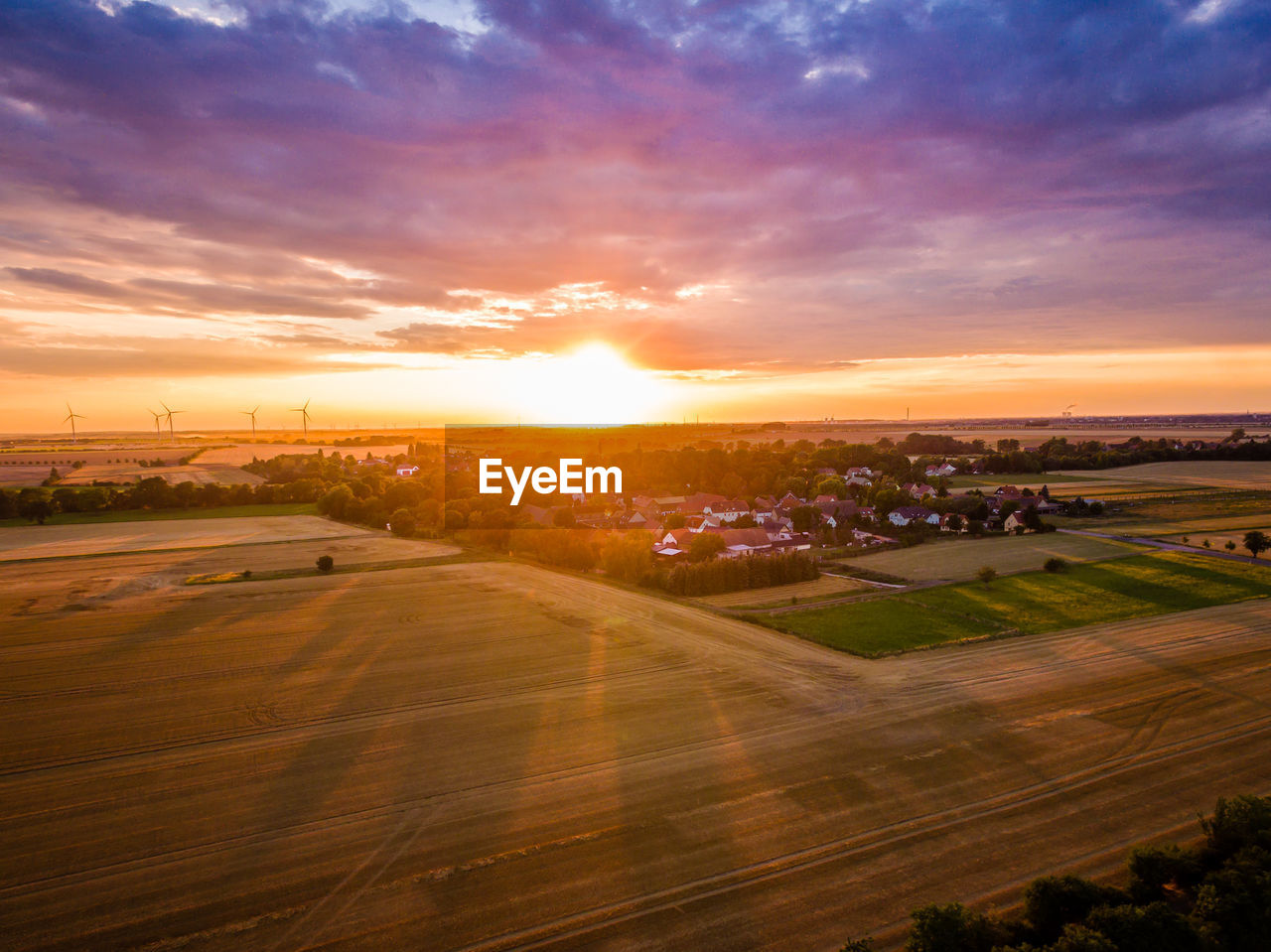 Agriculture field against sky during sunset