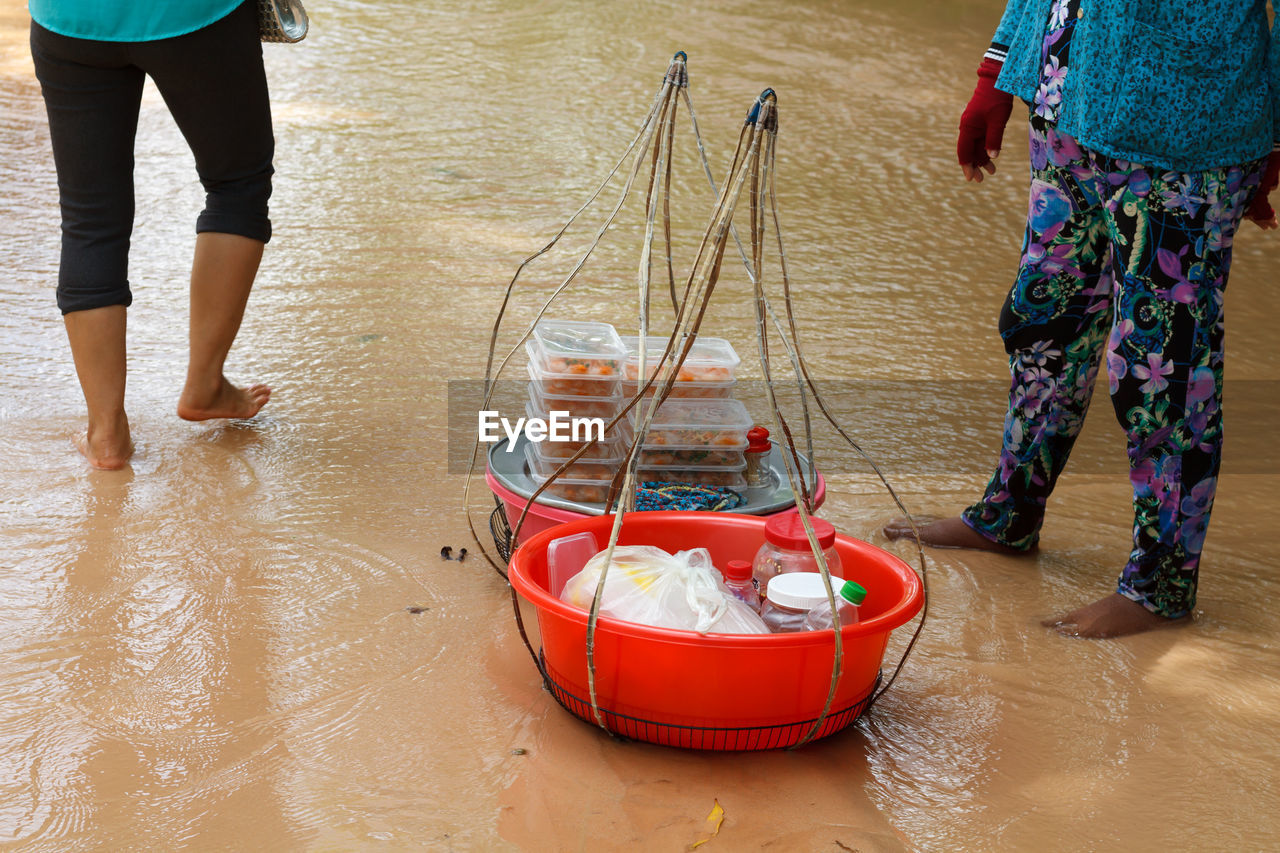 LOW SECTION OF PEOPLE STANDING BY FISHING NET