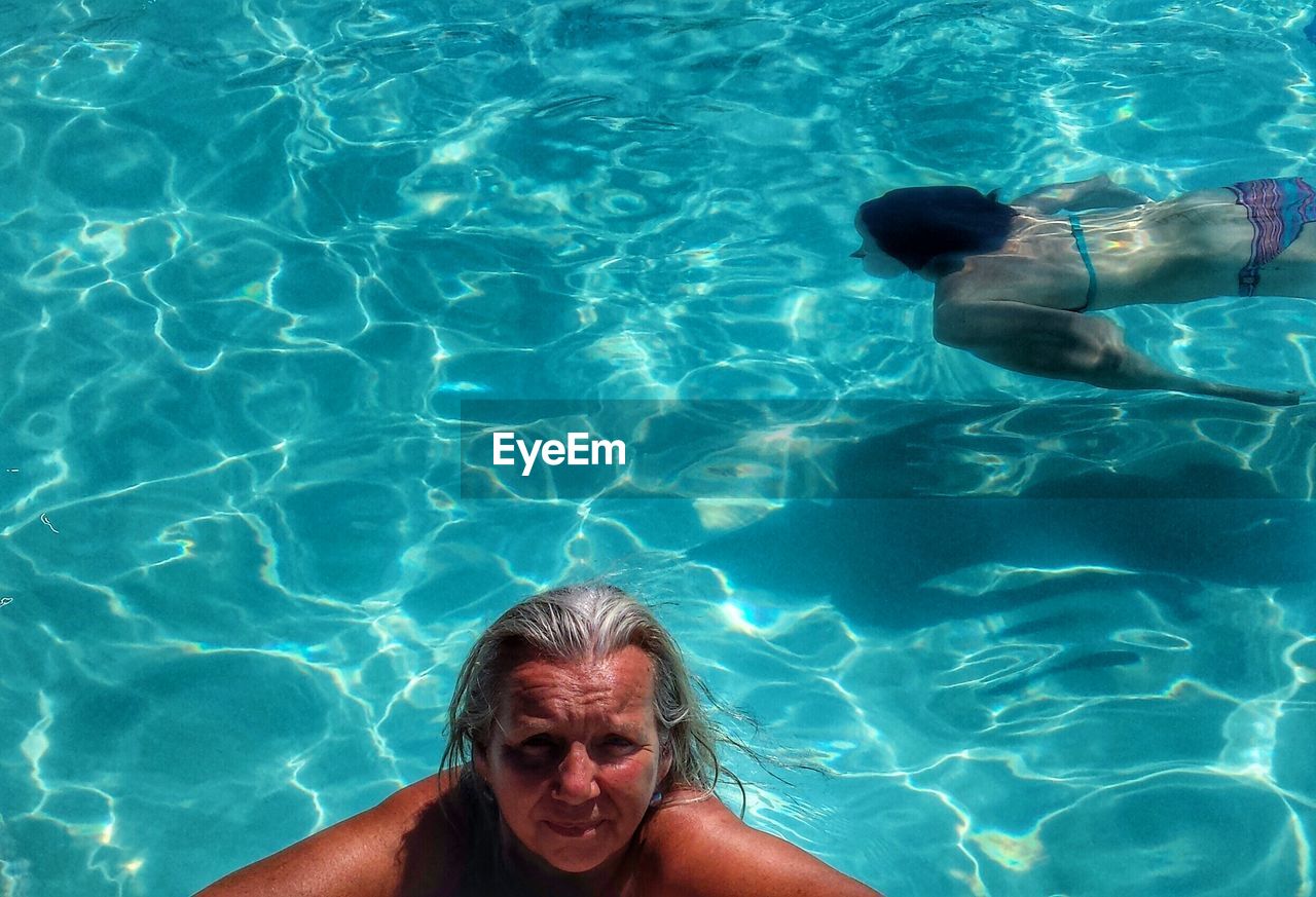 High angle view of woman swimming in swimming pool