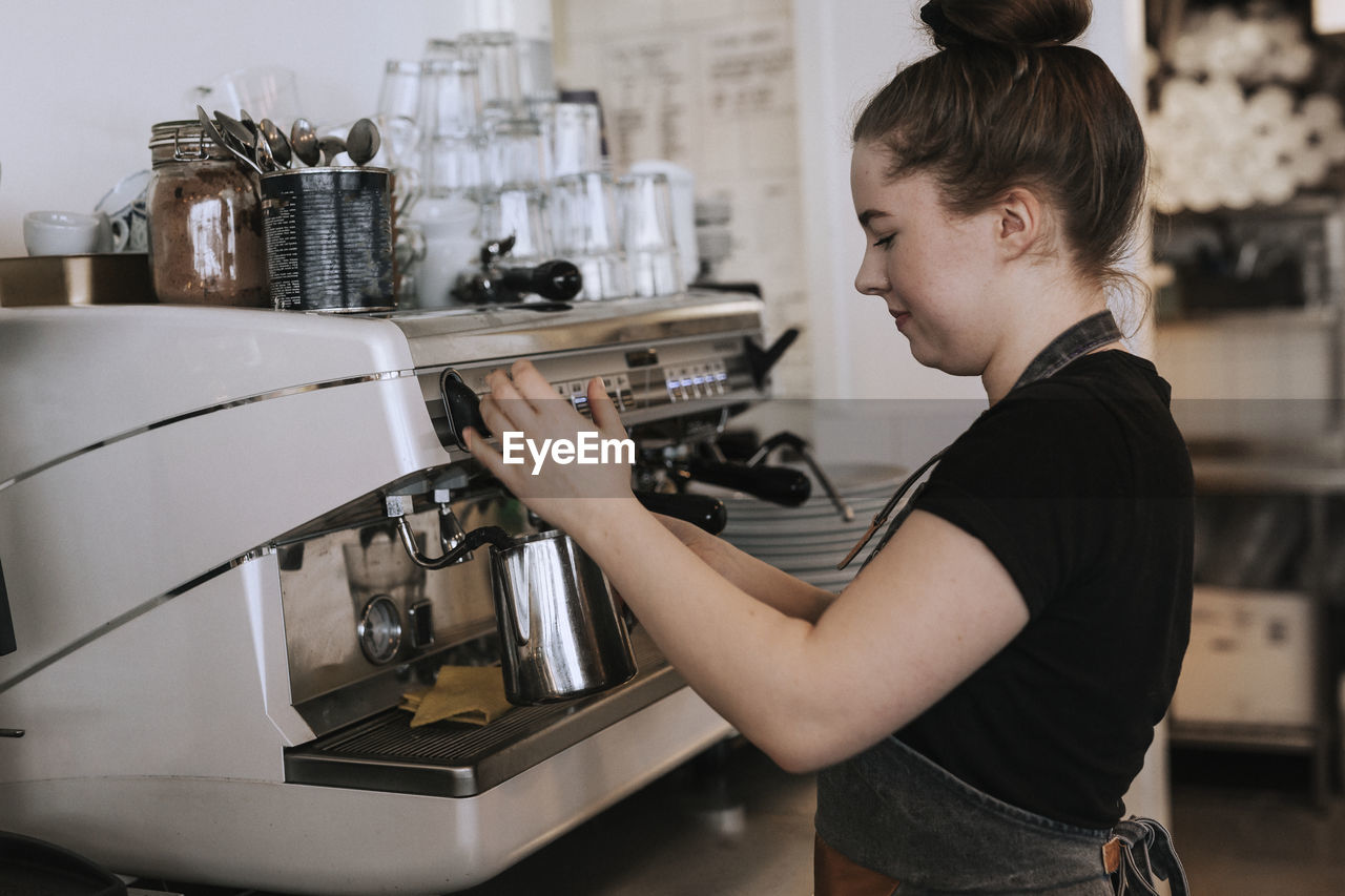 Smiling woman working in cafe