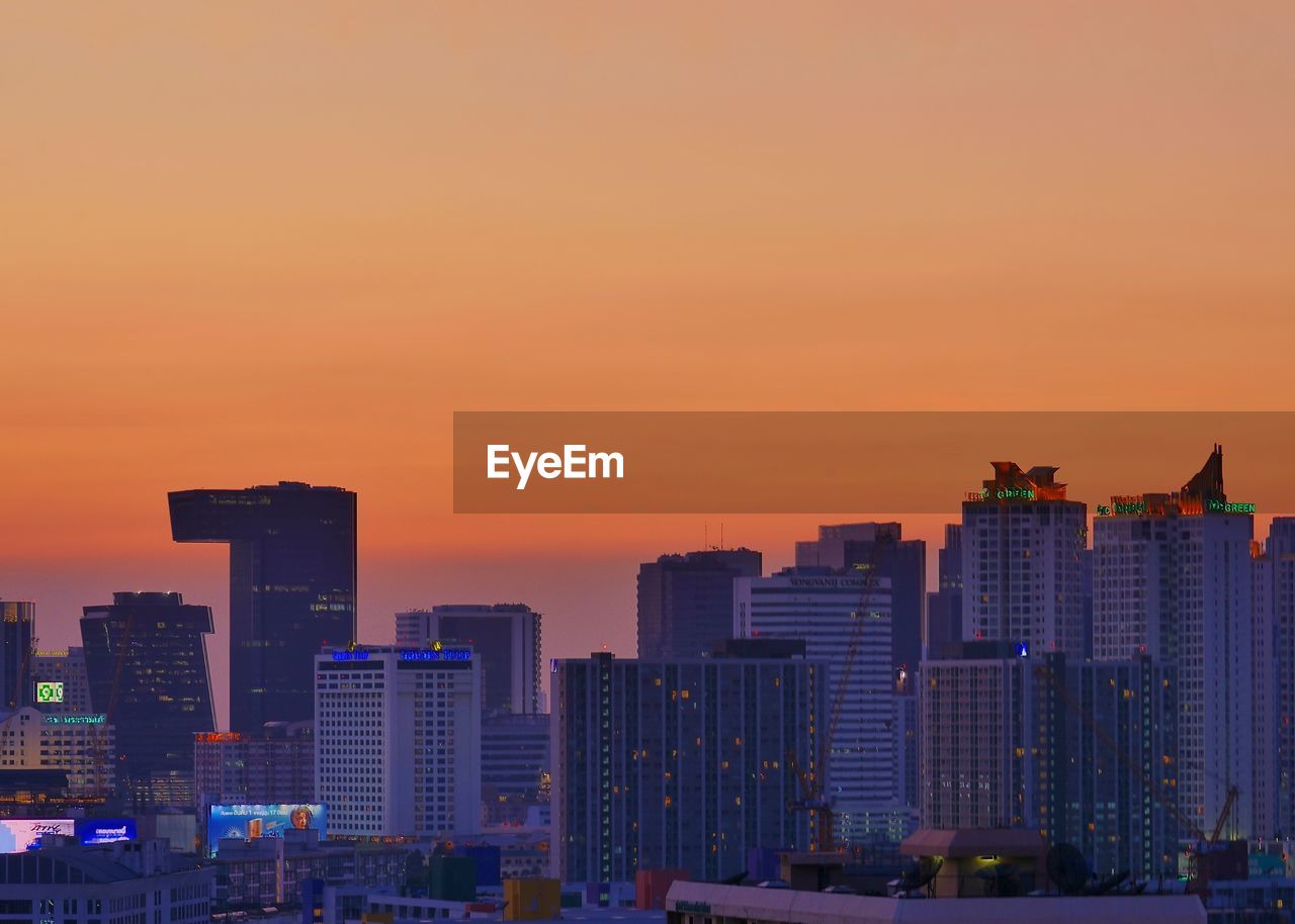 Modern buildings against romantic sky at sunset