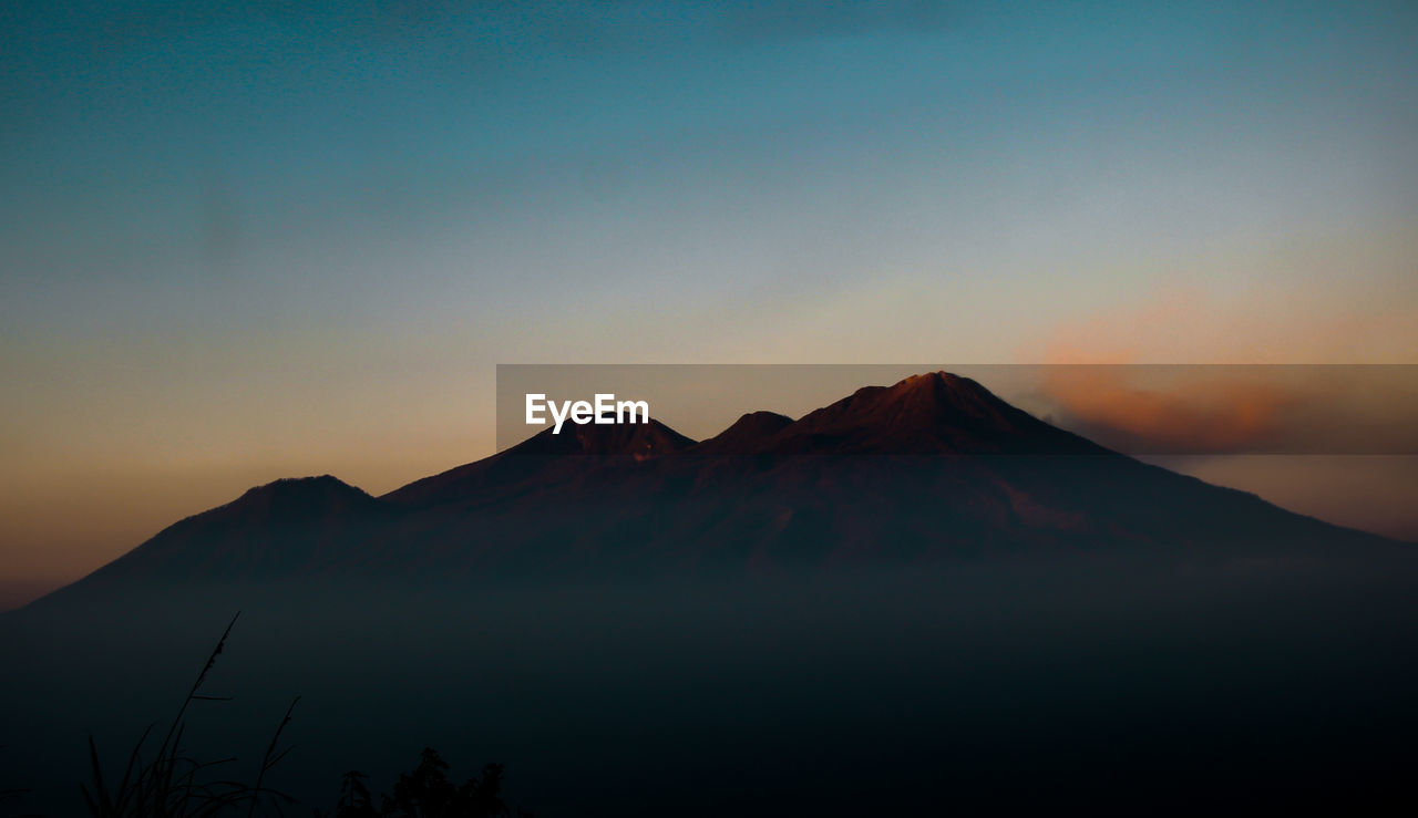 Scenic view of mountain against sky during sunset