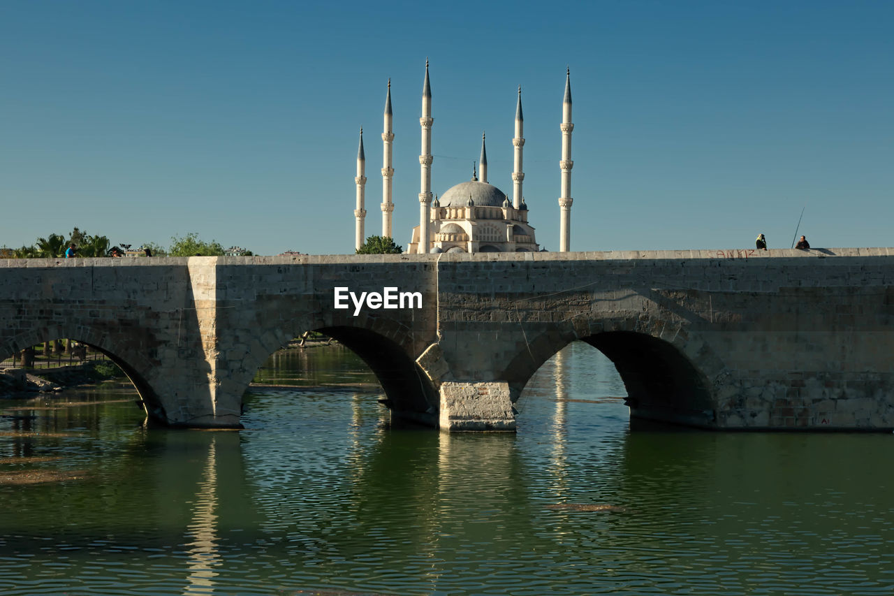 Bridge over river against blue sky