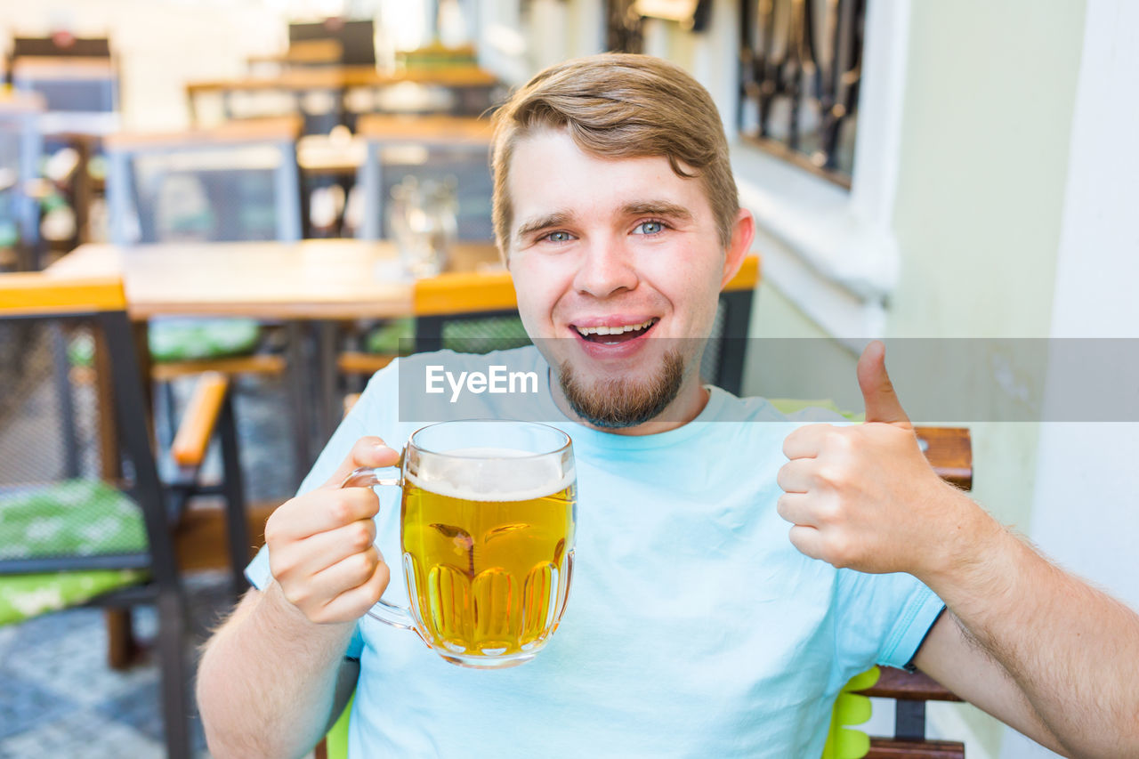 PORTRAIT OF A YOUNG MAN DRINKING GLASS