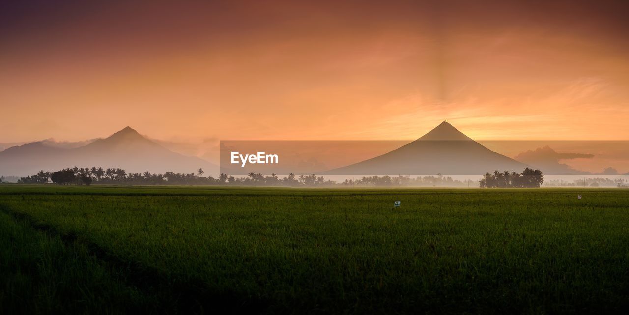 Scenic view of mt mayon against sky during sunrise