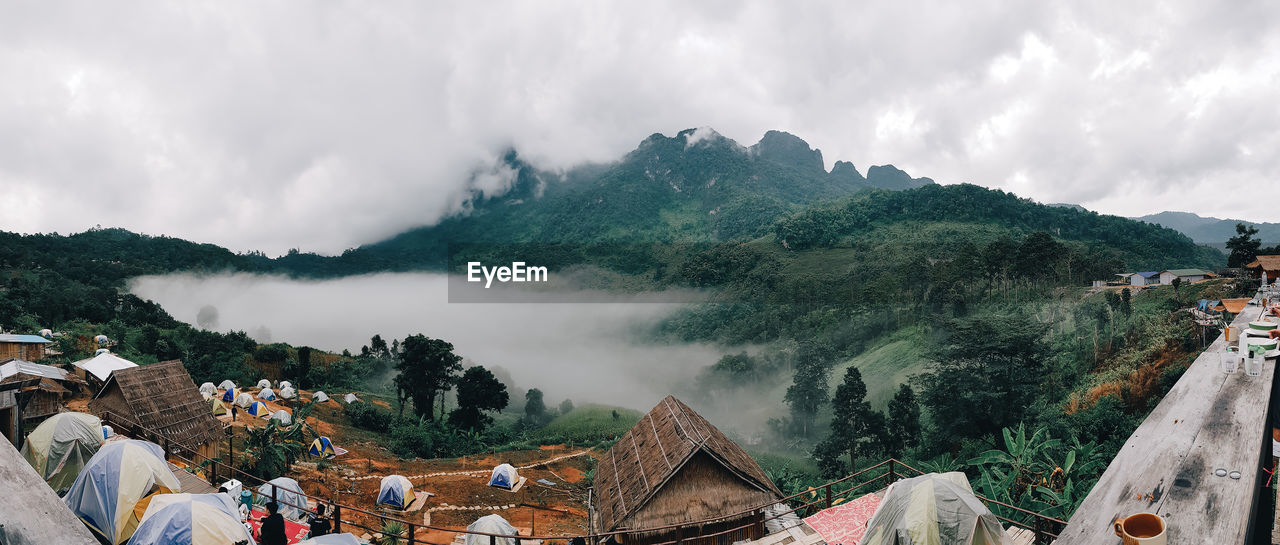 Panoramic view of trees and buildings against sky