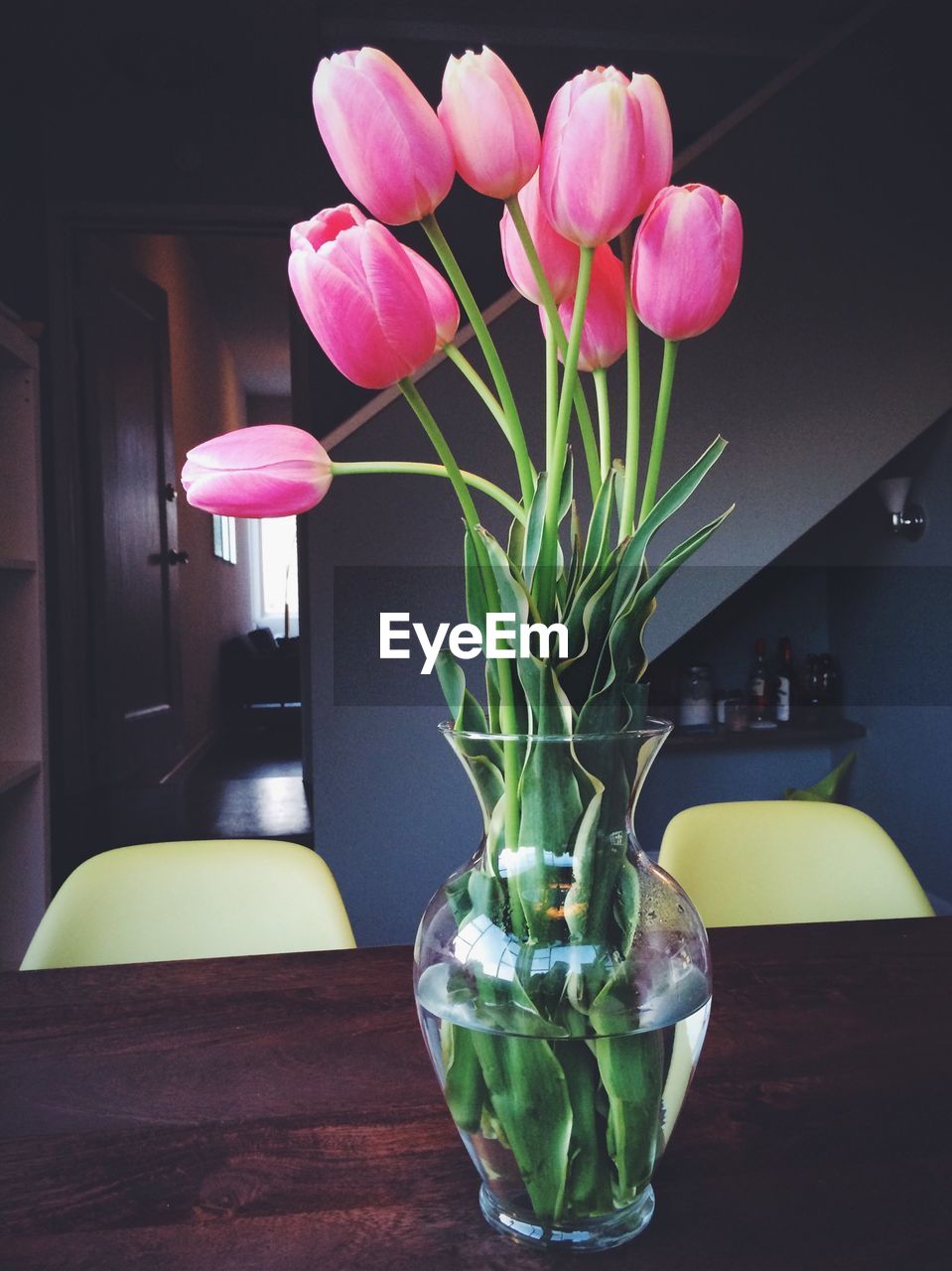 Tulips in vase on table at home