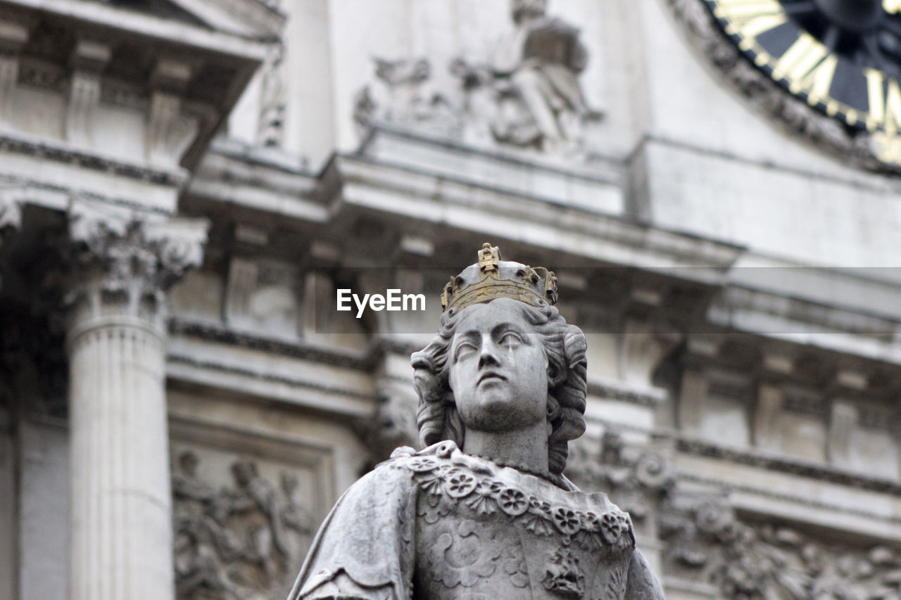 Low angle view of statue against building