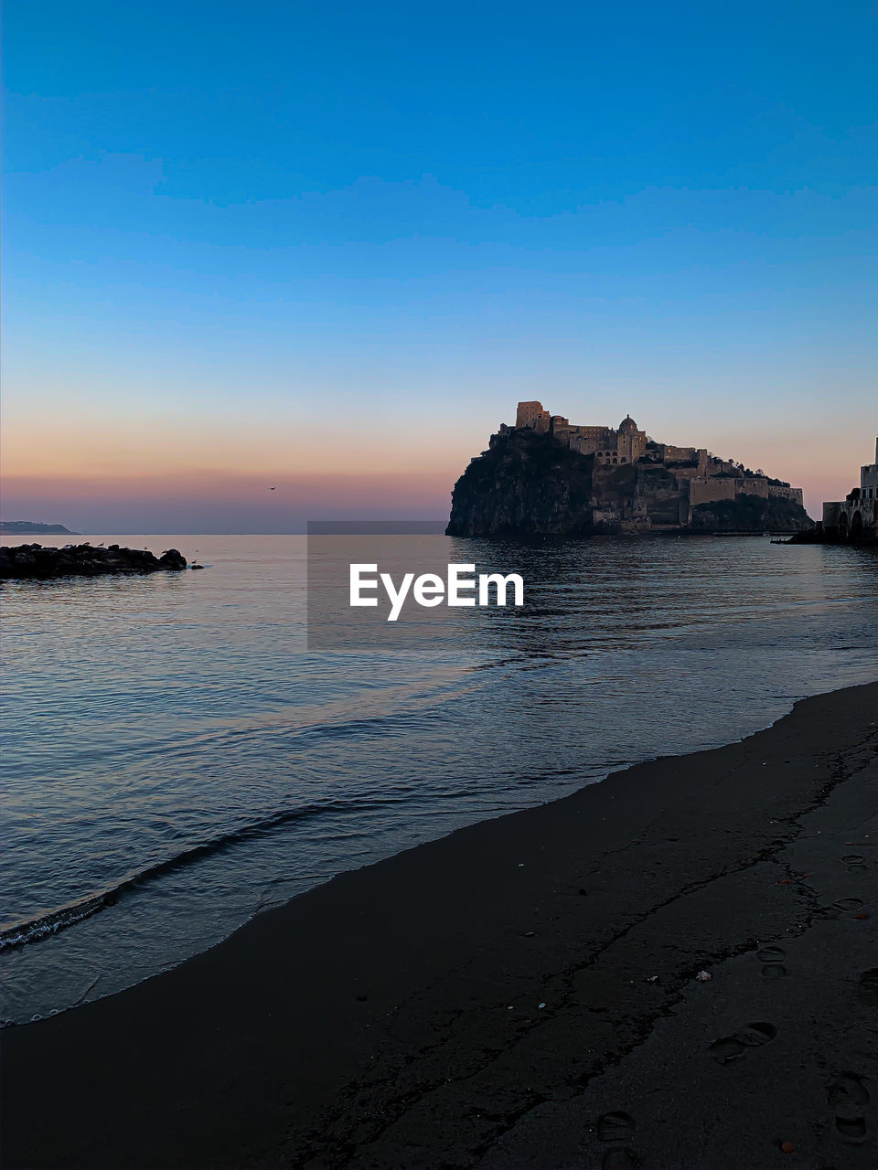 Scenic view of sea against clear sky at sunset