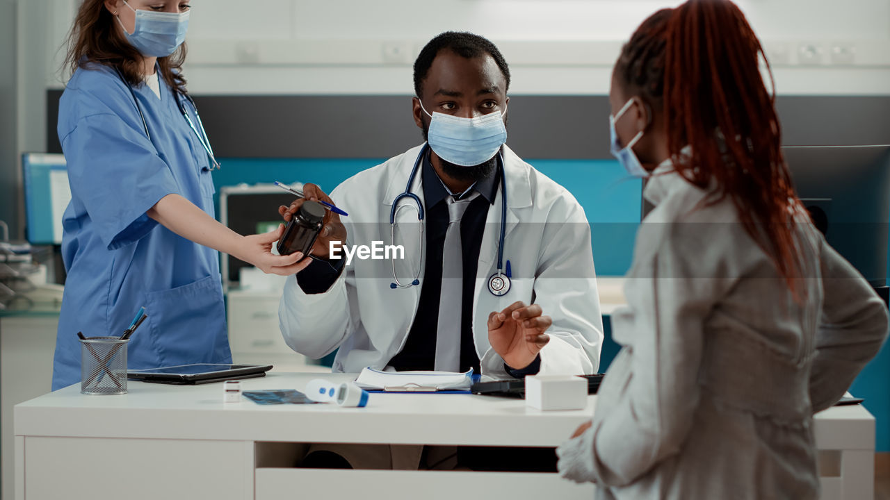 Female doctor examining patient in clinic