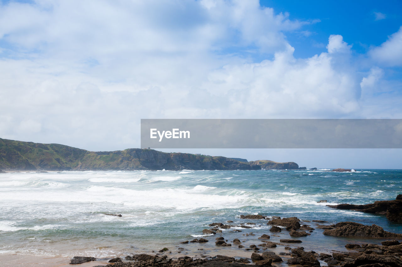 sea, water, land, sky, body of water, beach, cloud, ocean, shore, scenics - nature, wave, beauty in nature, nature, wind wave, rock, coast, environment, horizon, travel destinations, coastline, motion, landscape, travel, tranquility, no people, sports, day, outdoors, water sports, tourism, sand, bay, holiday, tranquil scene, trip, blue, vacation, cove, seascape, water's edge, mountain