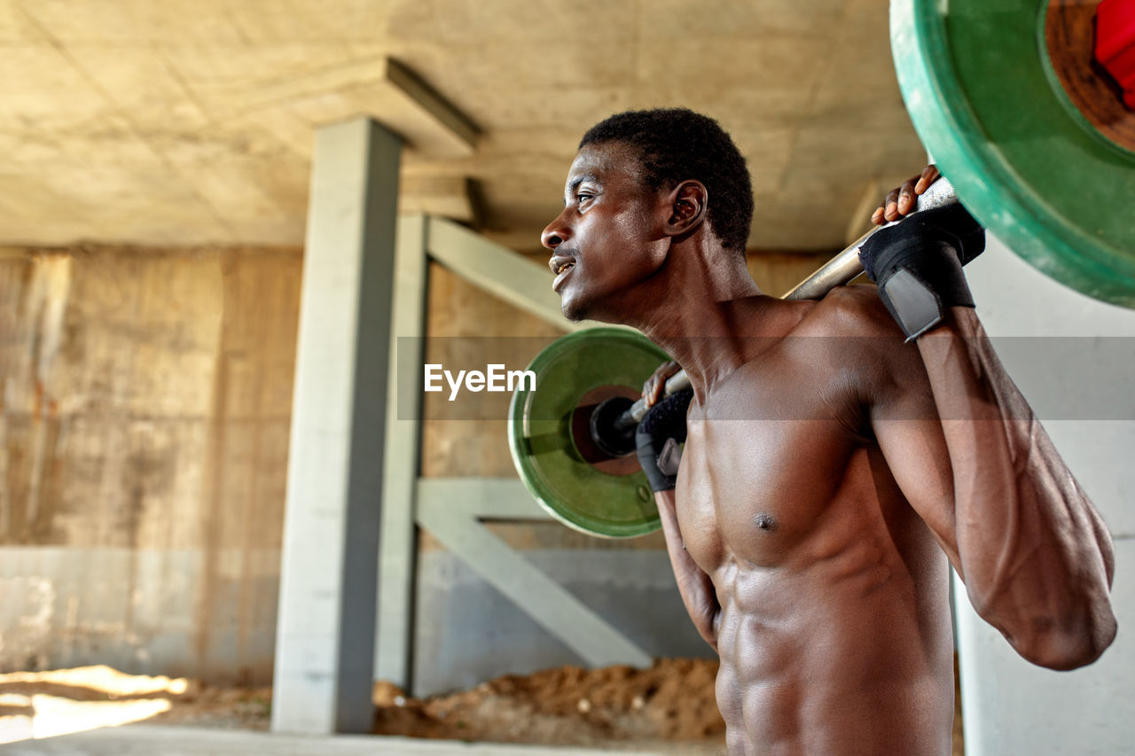 low angle view of man exercising in gym at home