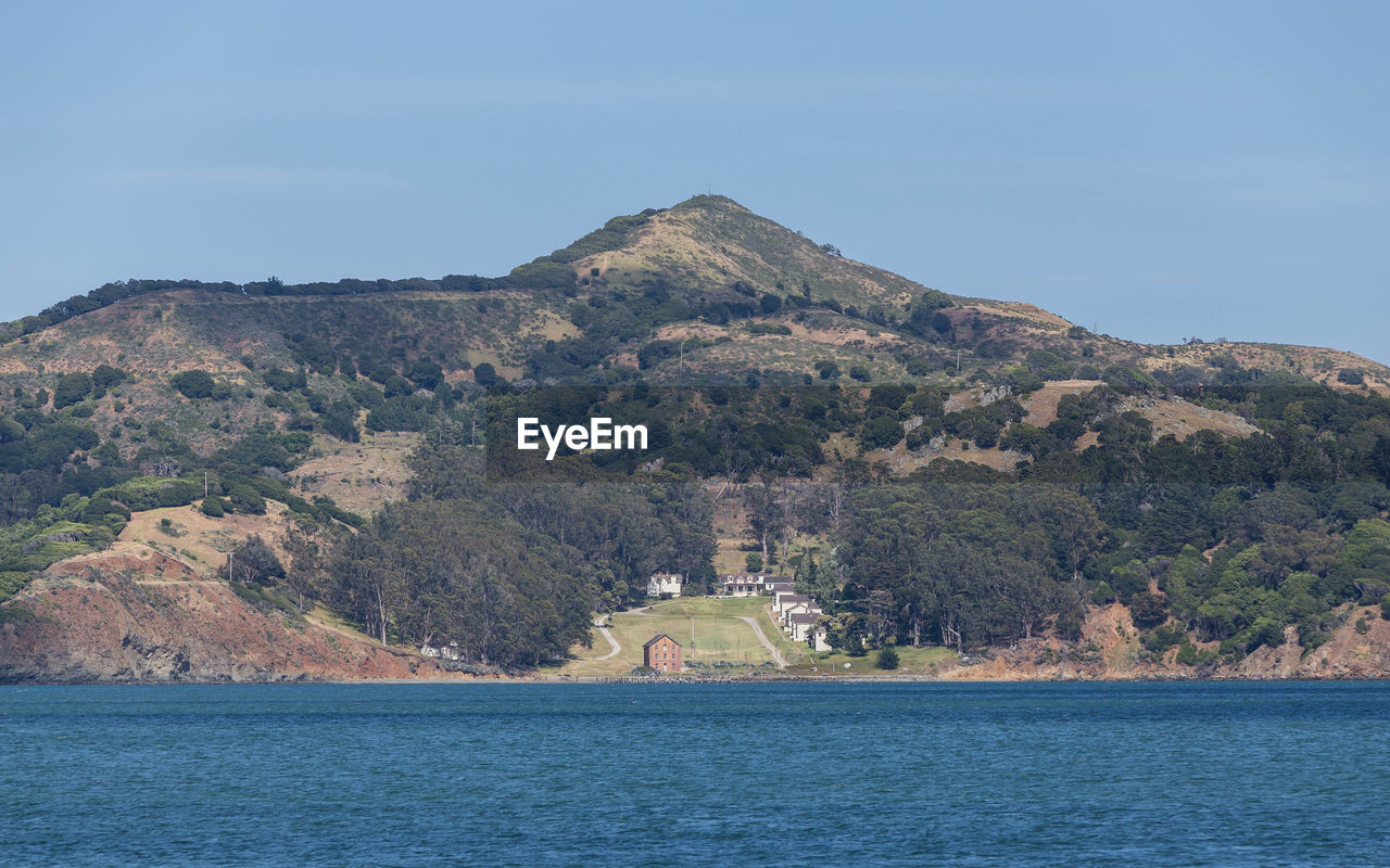 Scenic view of sea and mountains against sky