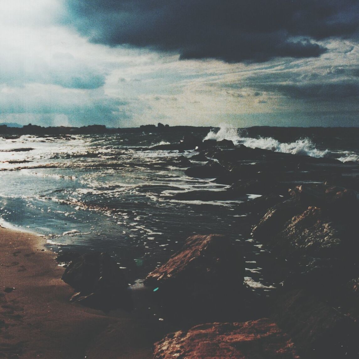 Scenic view of sea against cloudy sky