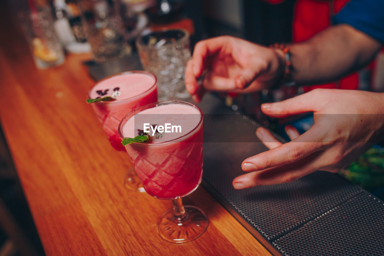 Close-up of drinks on table with people on background