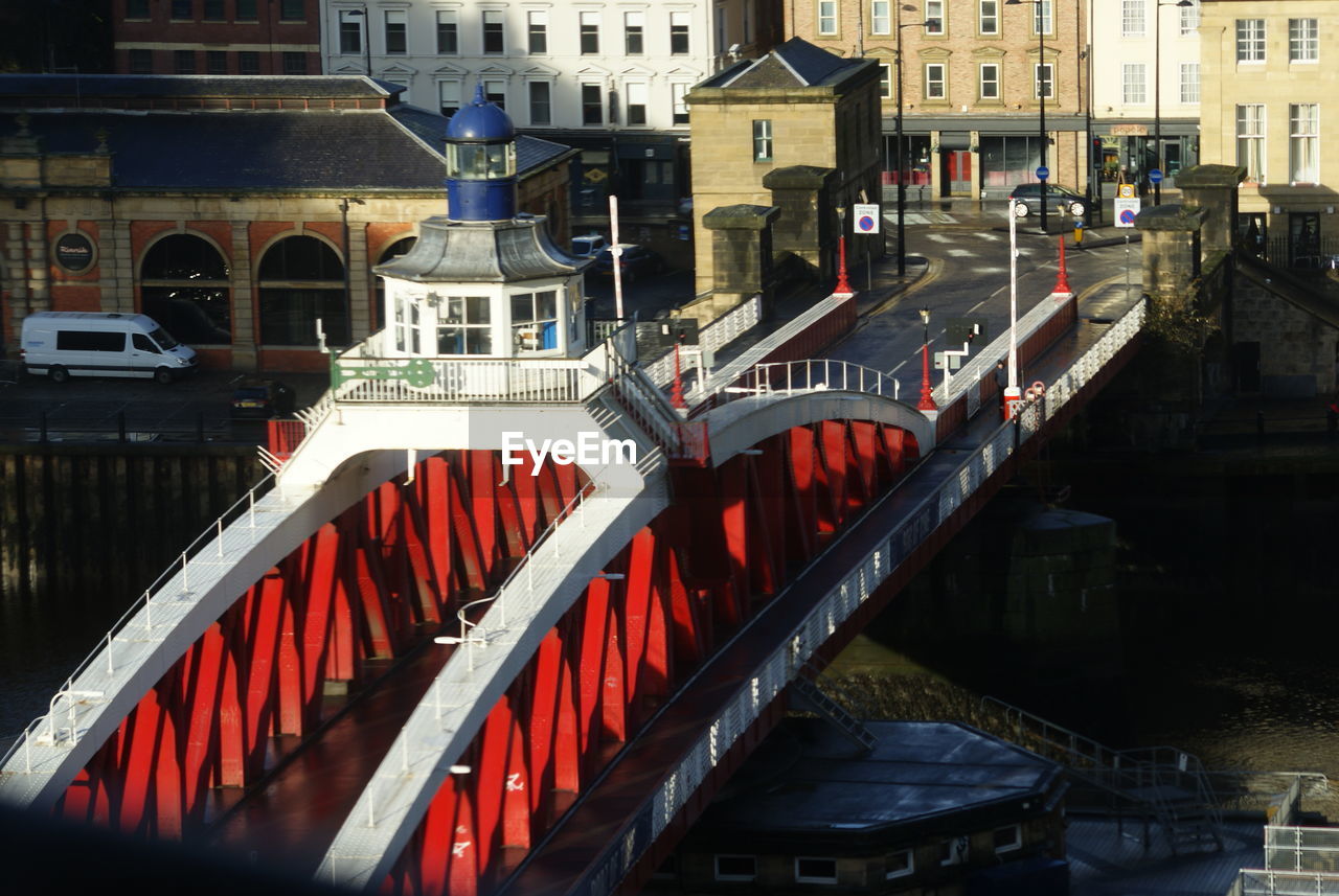 HIGH ANGLE VIEW OF BRIDGE OVER CANAL AMIDST BUILDINGS