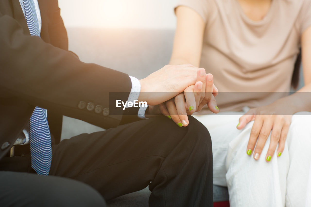 Professional psychiatrist hands together holding palm of her patient