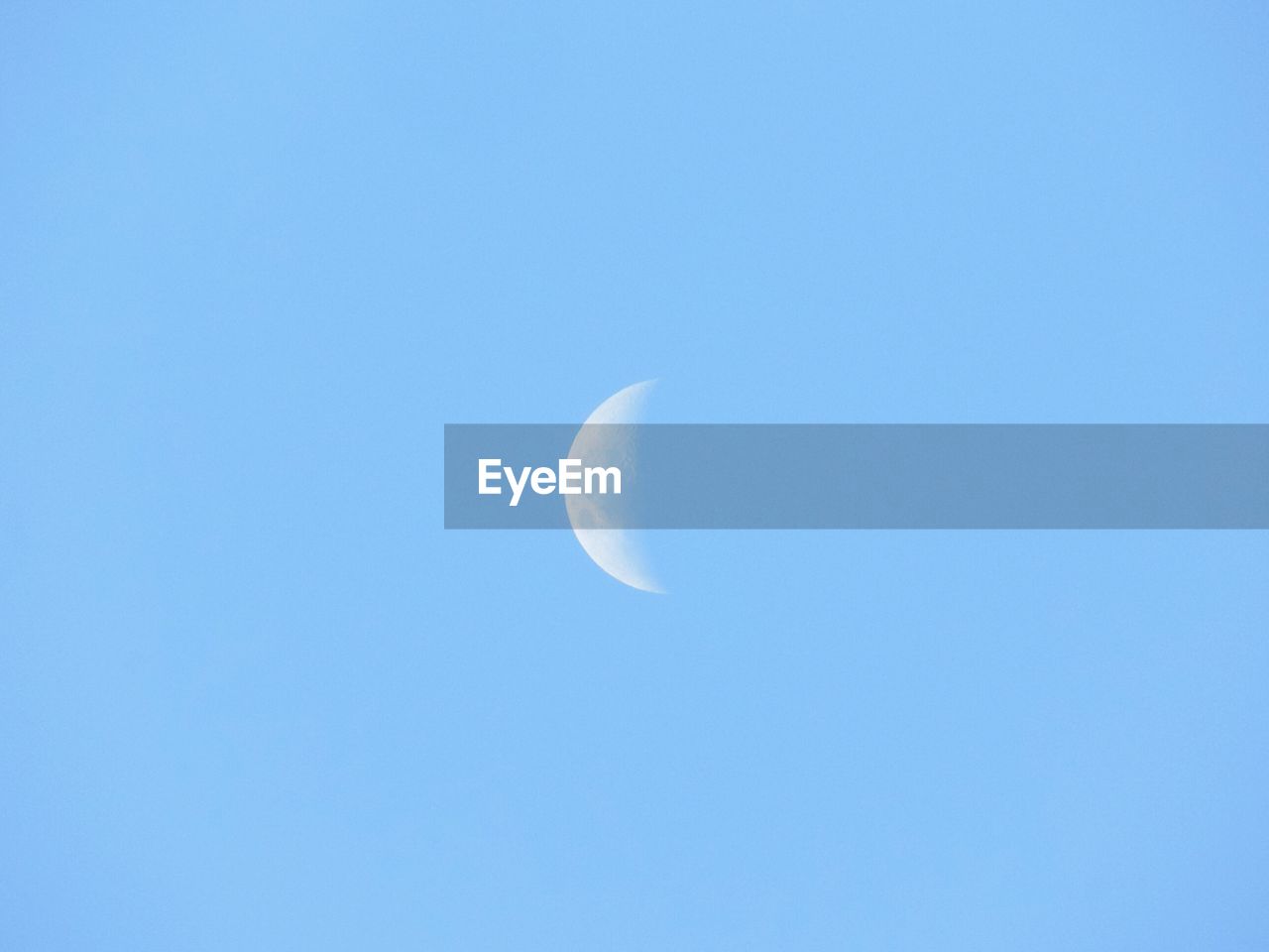 LOW ANGLE VIEW OF MOON IN SKY