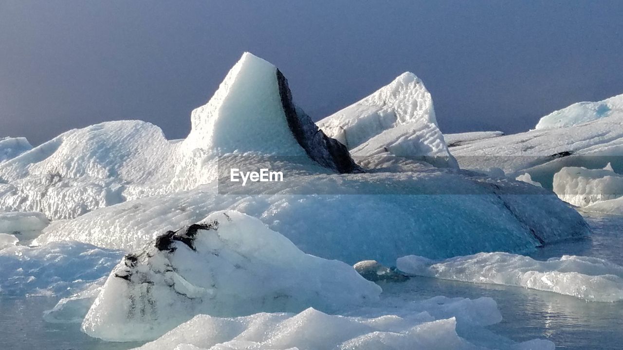 FROZEN LAKE AGAINST MOUNTAIN