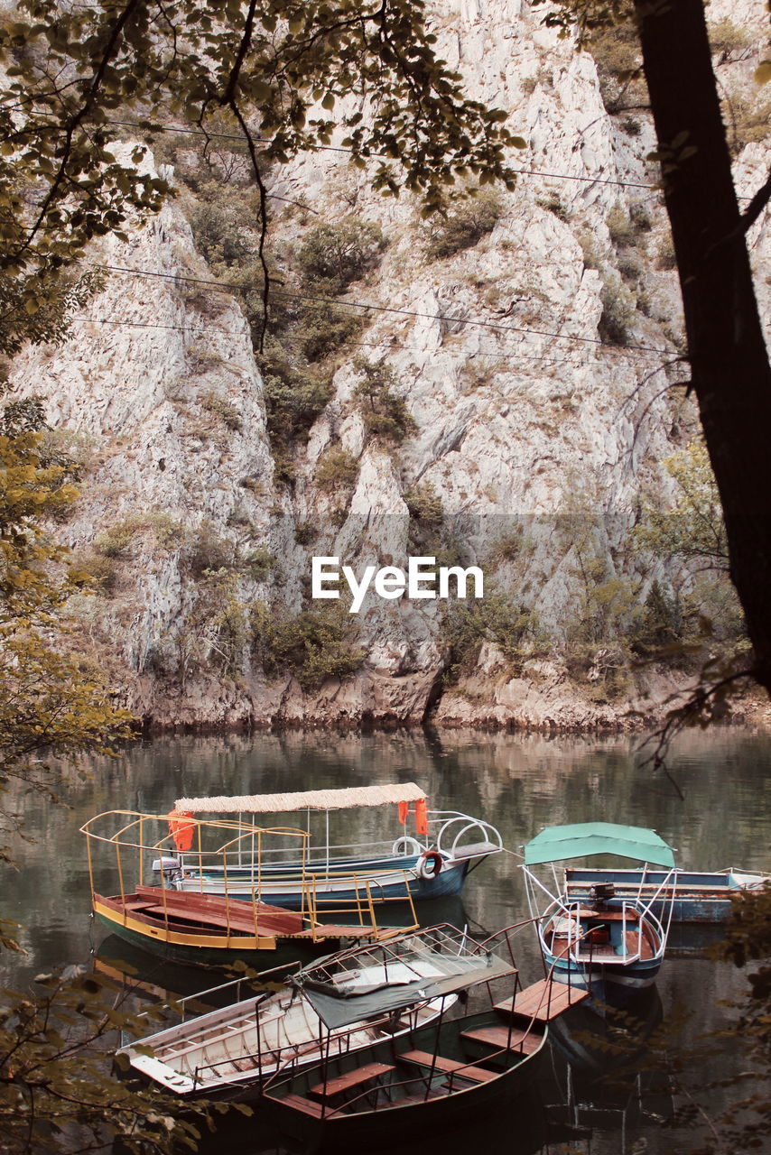 Boats moored on rock by lake - matka canyon