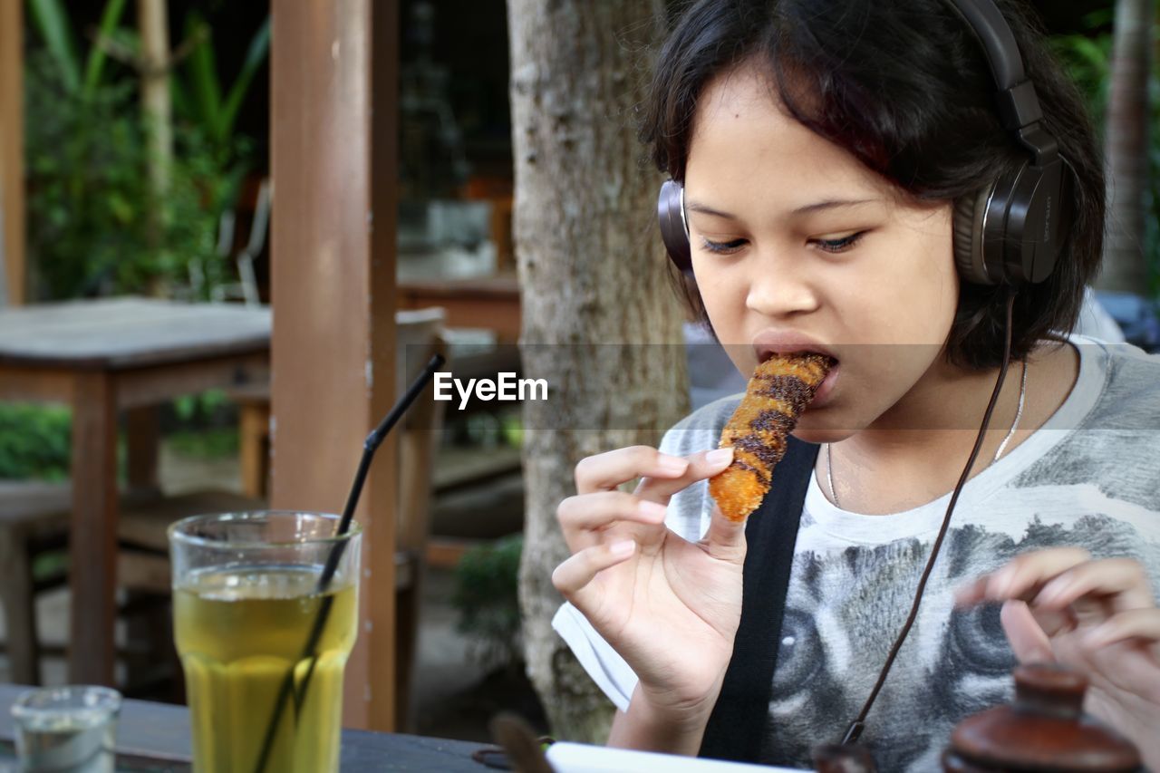 Girl having food and drink at restaurant