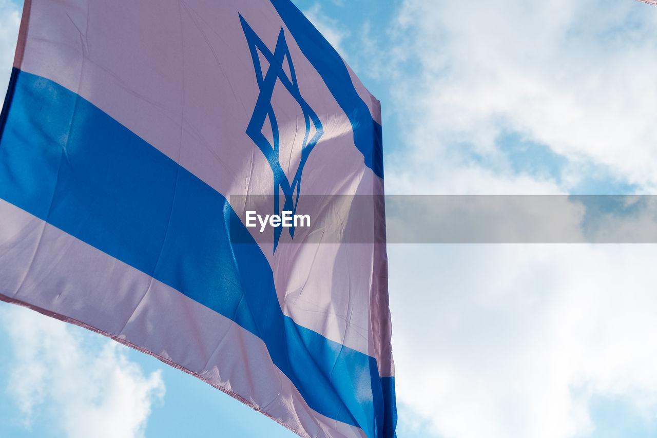 LOW ANGLE VIEW OF FLAG AGAINST SKY