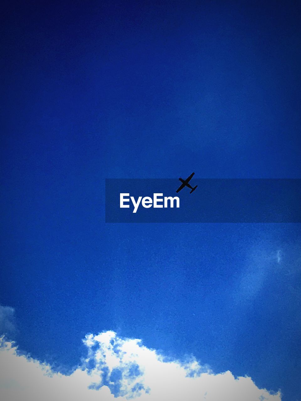 LOW ANGLE VIEW OF AIRPLANE FLYING IN SKY