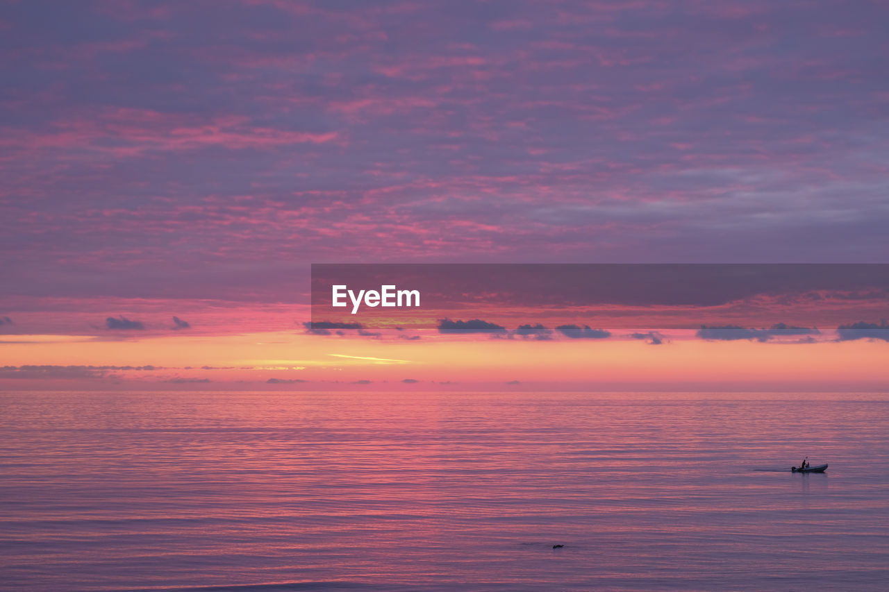 Scenic view of sea against orange sky