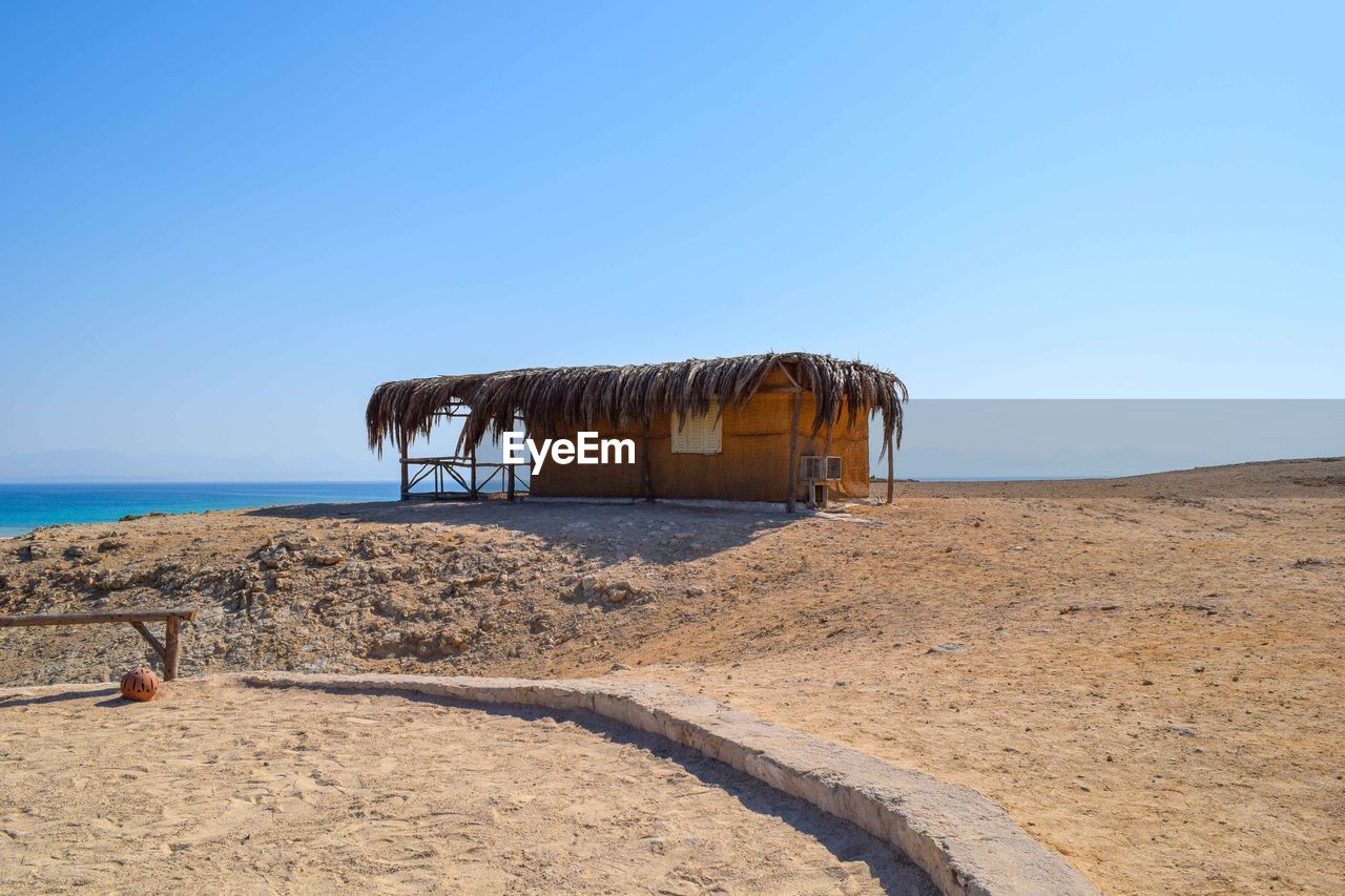 BUILT STRUCTURE ON BEACH AGAINST CLEAR SKY