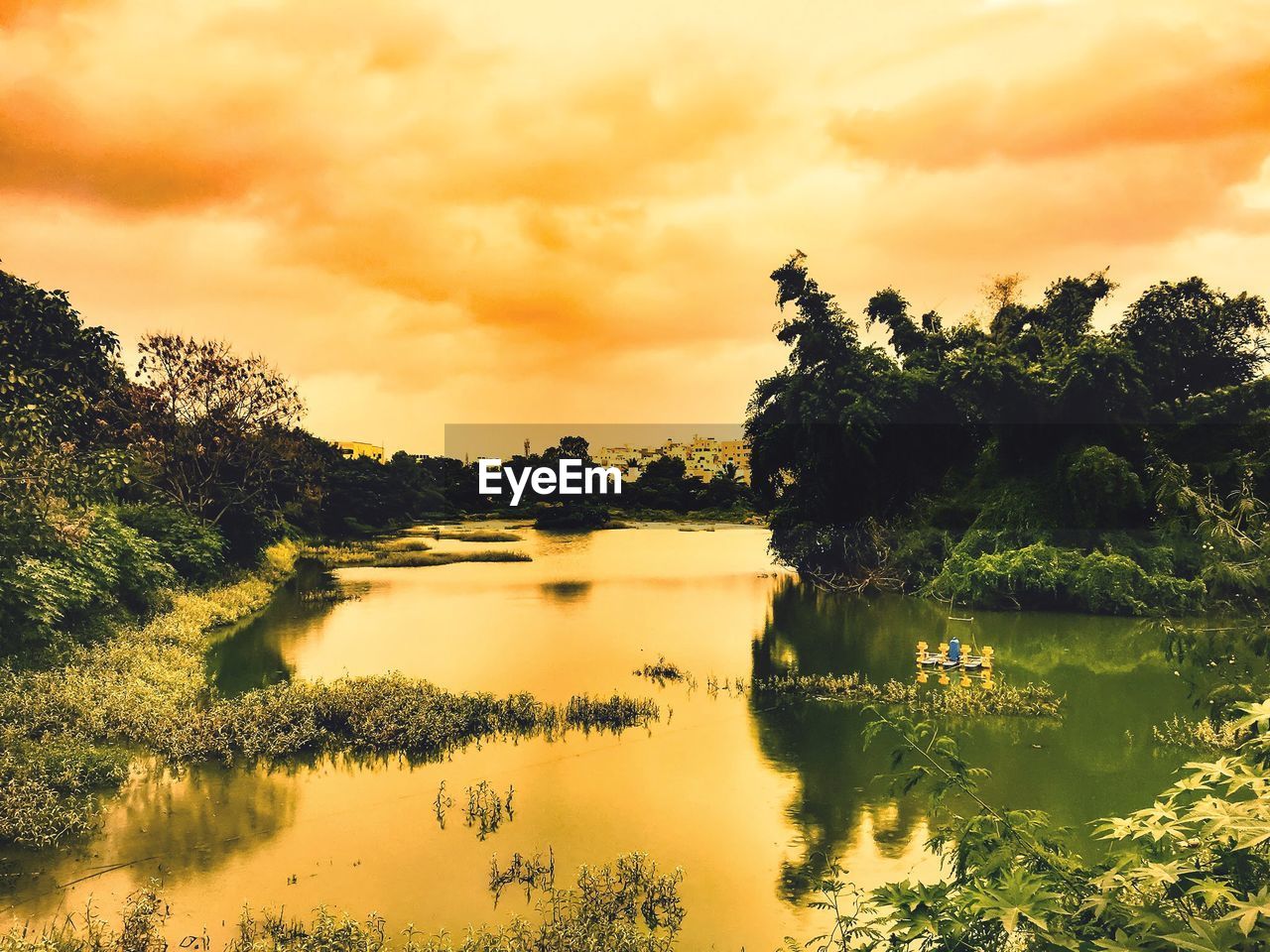 Scenic view of lake against sky during sunset