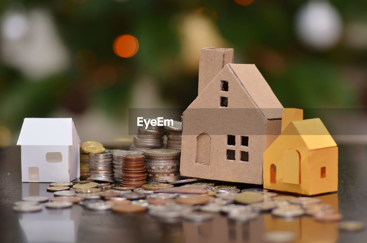 Close-up of coins and model home