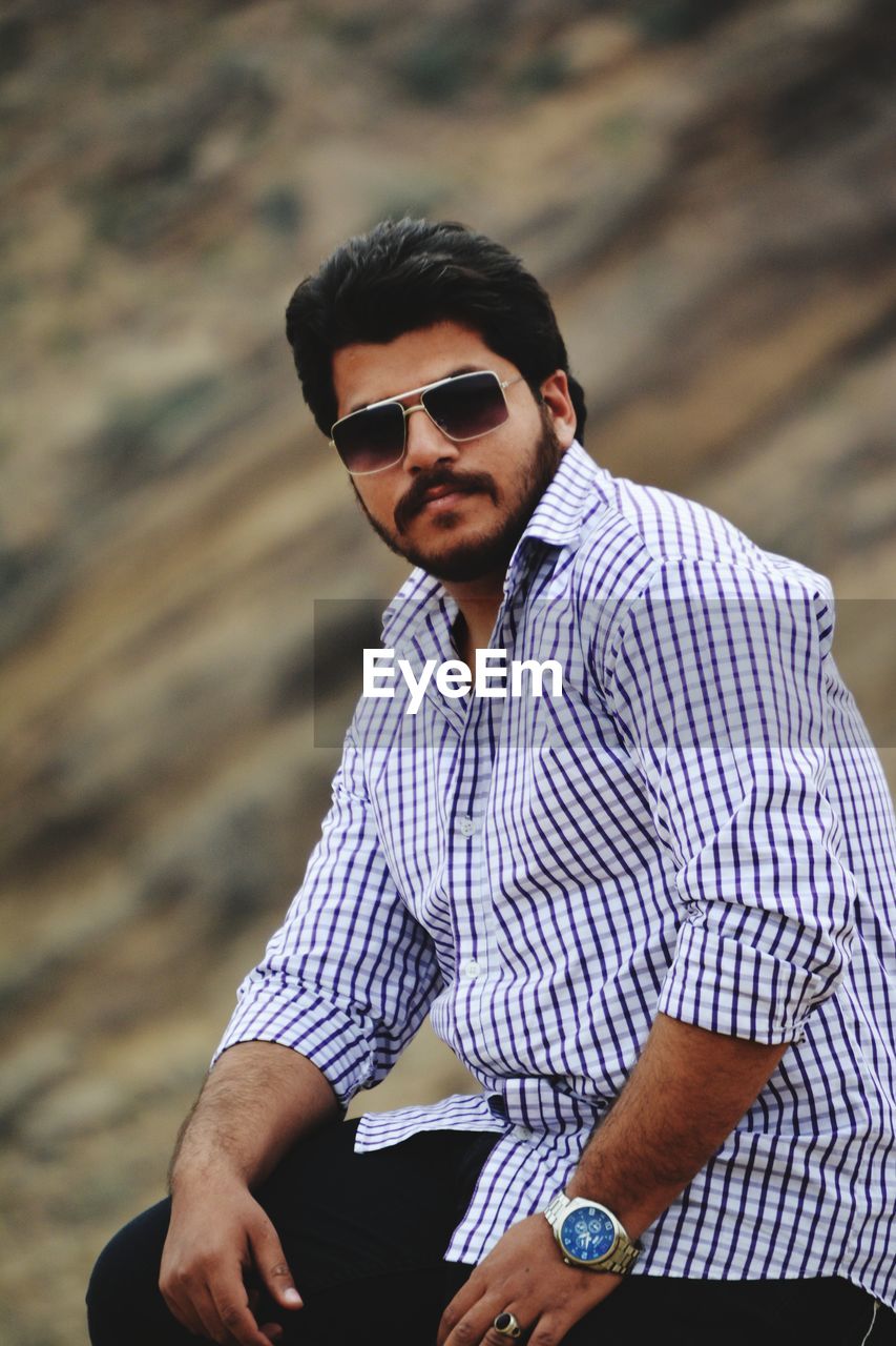 Young man wearing sunglasses standing outdoors