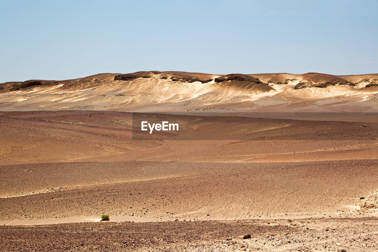 Scenic view of desert against clear sky