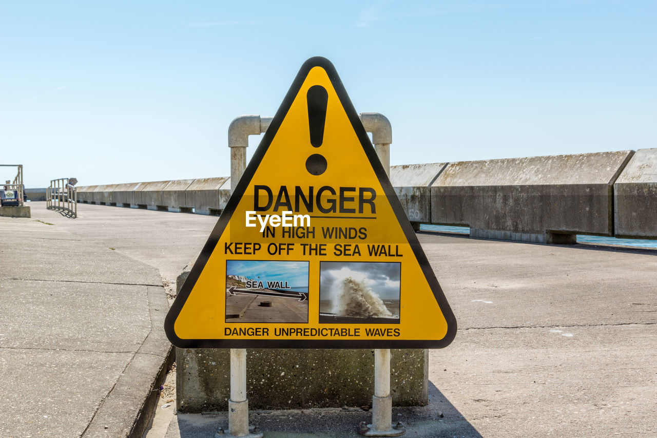 Close-up of road signs against clear sky