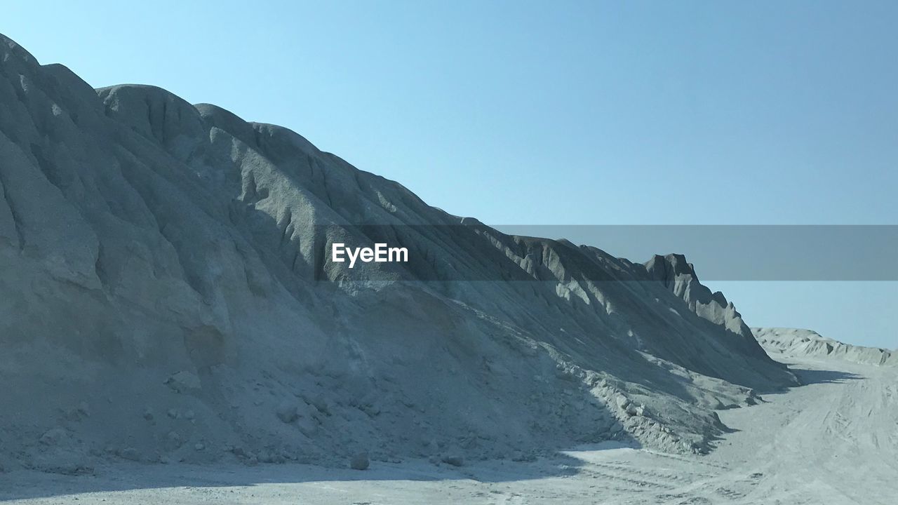 Scenic view of snowcapped mountains against clear blue sky