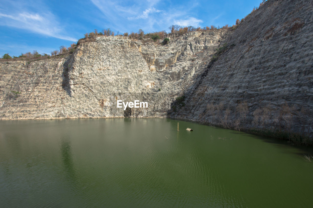 SCENIC VIEW OF LAKE AND ROCK FORMATION AGAINST SKY