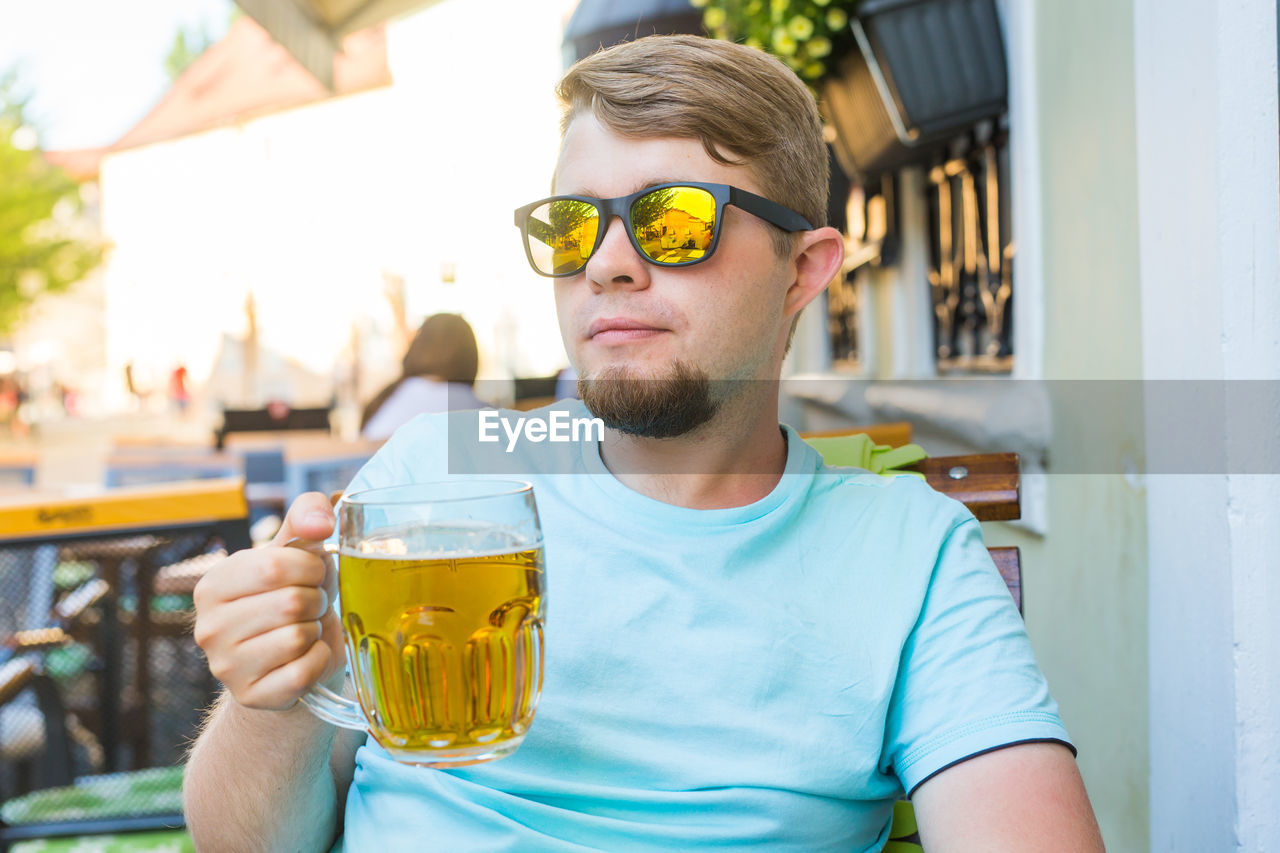 PORTRAIT OF YOUNG MAN DRINKING GLASS ON A WOMAN