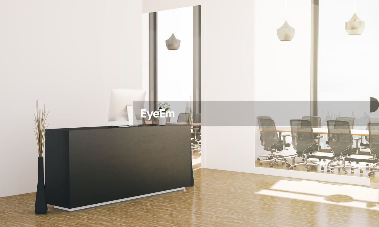 Empty chairs and table in office