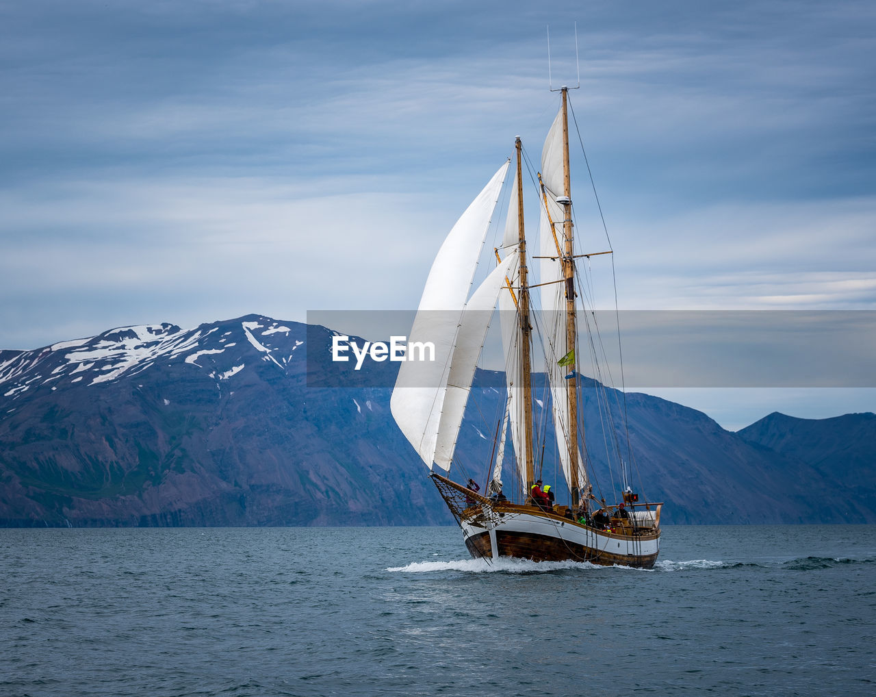 Sailboat sailing in sea against sky