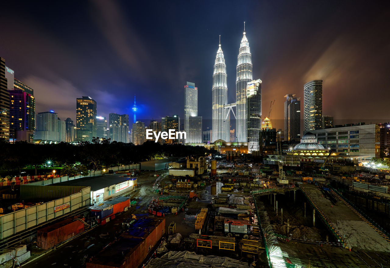 High angle view of illuminated city against sky