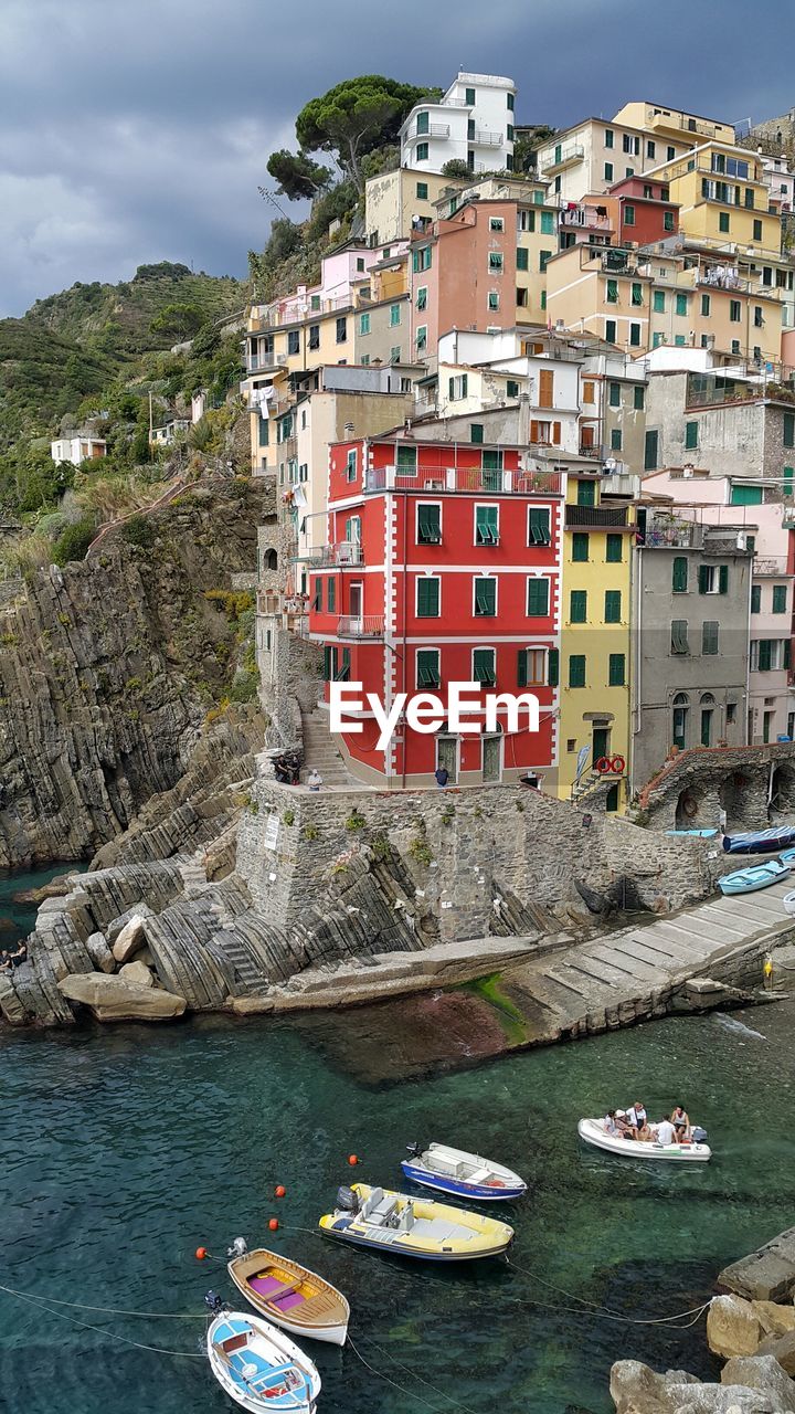 Boats in river against buildings