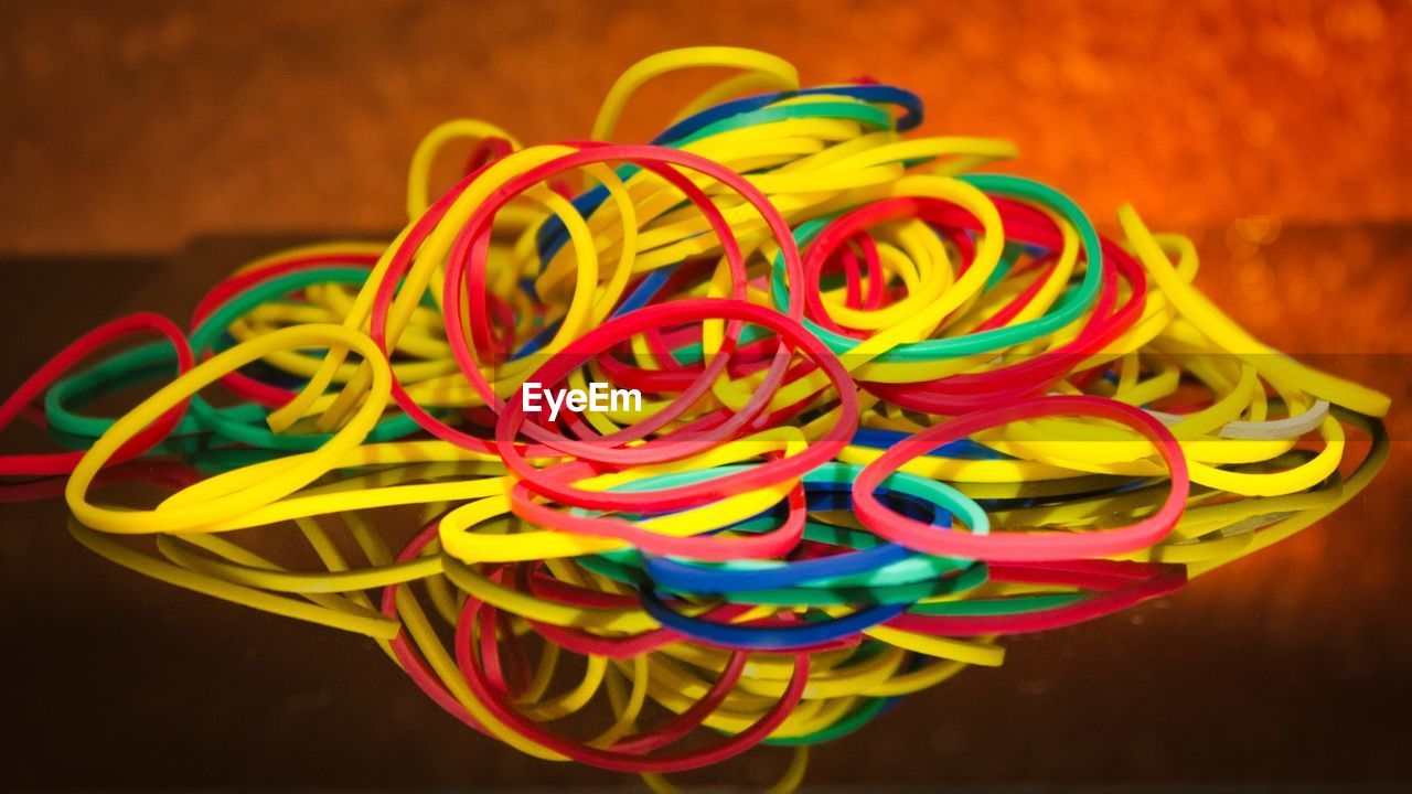 Close-up of colorful rubber bands on table