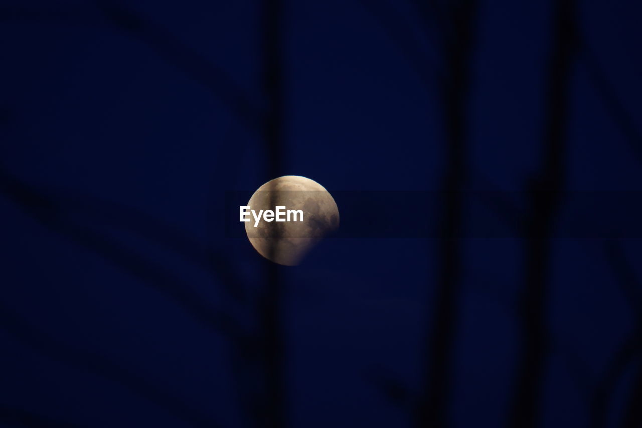 CLOSE-UP OF MOON AGAINST BLUE SKY